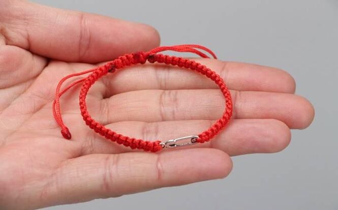 The red thread that protects against evil (on the left wrist) and attracts happiness (on the right wrist)